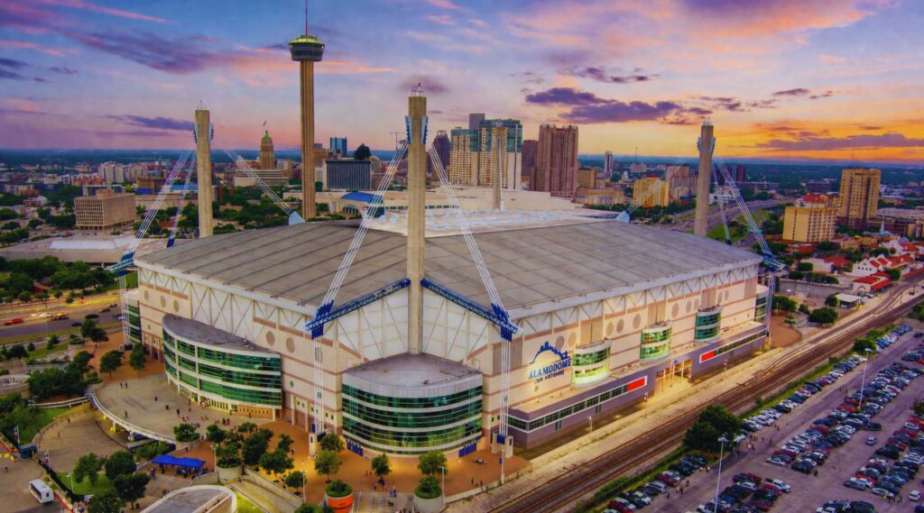 Alamodome San Antonio aerial view at sunset near downtown skyline