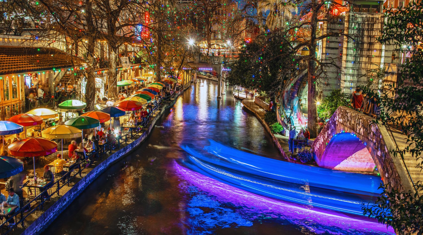 San Antonio River Walk at night with lights and entertainment