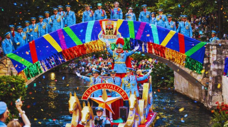 Texas Cavaliers River Parade 2026 with illuminated boats on San Antonio River Walk