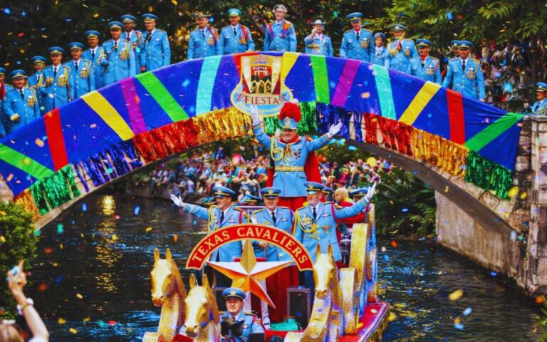 Texas Cavaliers River Parade 2026 with illuminated boats on San Antonio River Walk